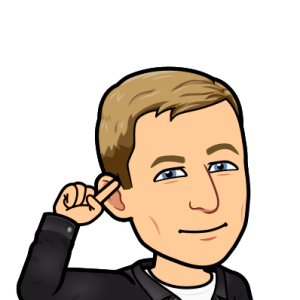 pointing to head and smiling with one eye brow raised