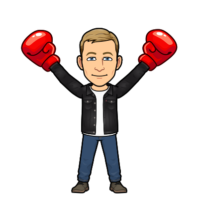 smiling standing victoriously with arms raised wearing red boxing gloves