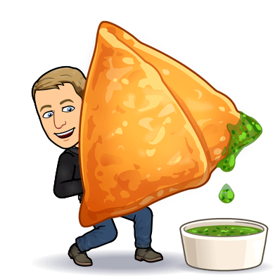 happily dipping a huge samosa into chutney