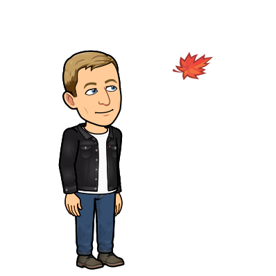 smiling while looking at an autumn leaf falling