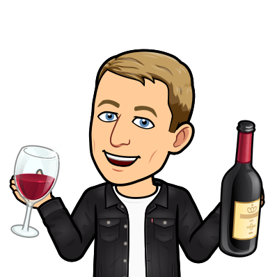 smiling while holding a glass of wine and wine bottle