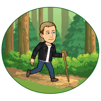 smiling and hiking in the woods with a walking stick