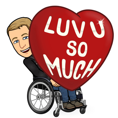 seated in a wheelchair carrying a giant red heart, love you so much