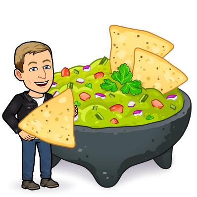 smiling and holding a chip next to a huge stone bowl of guacamole