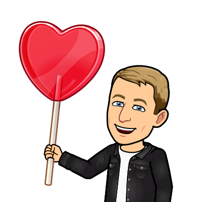 holding a giant heart shaped lollipop