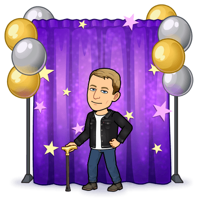 smiling standing in front of a photo backdrop curtain holding cane